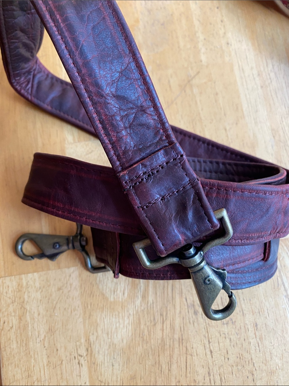 Maroon color bronze tone hardware strap for bag  42” used still in good conditio
